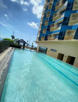 a swimming pool in front of a building at Family budget room, infront US of Embassy in Manila