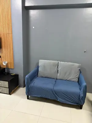 a blue couch sitting in a living room at Family budget room, infront US of Embassy in Manila