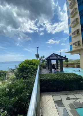 a view of the ocean from the balcony of a building at Cozy simple 1 bedroom in Manila