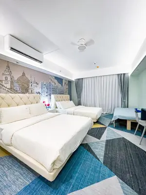 a hotel room with two beds and a desk at Lovely Penthouse near Airport, City of Dreams 8pax in Manila