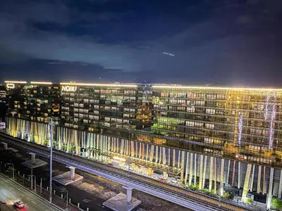a view of a large building at night at Lovely Penthouse across City of Dreams, Airport in Manila
