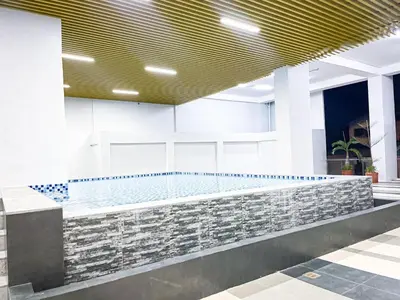 a pool in the lobby of a building at Lovely Penthouse across City of Dreams, Airport in Manila