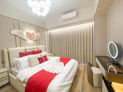 a bedroom with a bed with a red and white blanket at Cozy 3BR in Manila Bay near Okada II 12pax in Manila