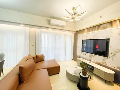 a living room with a couch and a flat screen tv at Cozy 3BR in Manila Bay near Okada II 12pax in Manila