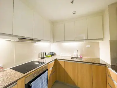 a kitchen with white cabinets and a sink at Cozy 3BR in Manila Bay near Okada II 12pax in Manila