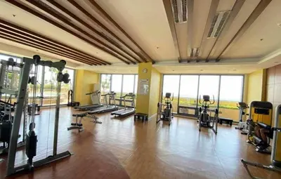 a gym with several treadmills and exercise bikes at Studio type unit 1, infront of US Embassy Manila in Manila