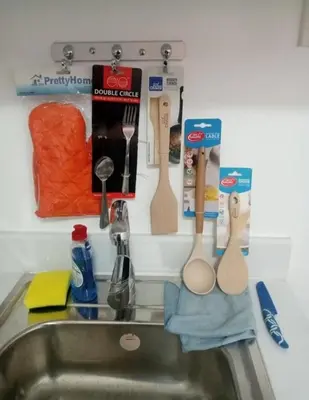 a kitchen sink with utensils hanging on a wall at Studio type unit 1, infront of US Embassy Manila in Manila