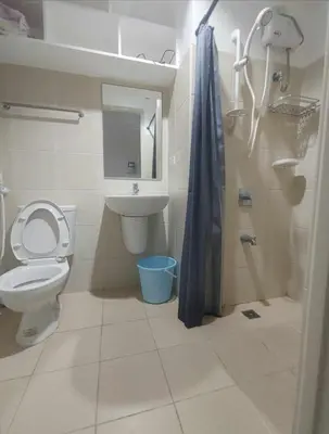a bathroom with a toilet and a sink and a shower at Studio type unit 1, infront of US Embassy Manila in Manila