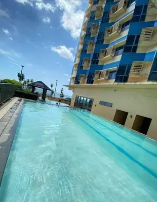 a large swimming pool in front of a building at Studio type unit 1, infront of US Embassy Manila in Manila