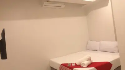 a small room with a small bed with a pillow on it at OYO 1128 HOTEL SANGCO in Manila