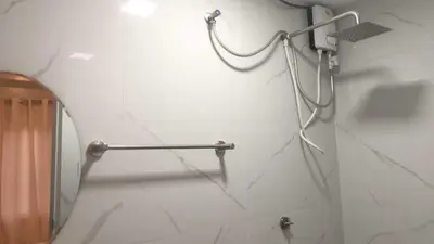a bathroom with a mirror and a towel rack at OYO 1128 HOTEL SANGCO in Manila