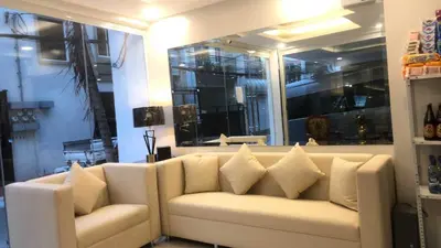 a living room with a white couch with pillows at OYO 1128 HOTEL SANGCO in Manila
