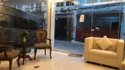 a living room with chairs and a table and a window at OYO 1128 HOTEL SANGCO in Manila