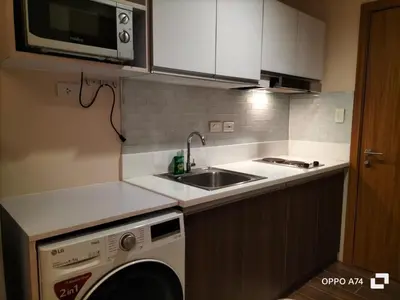 a kitchen with a sink and a washing machine at Destina at Air Residence Makati, MetroManila, Netflx in Manila