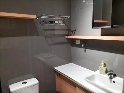 a bathroom with a sink and a toilet and a mirror at Destina at Air Residence Makati, MetroManila, Netflx in Manila