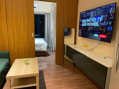 a room with a television and a room with a bed at Destina at Air Residence Makati, MetroManila, Netflx in Manila