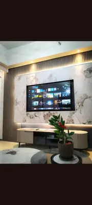 a living room with a flat screen tv on a wall at One winstar realty corp in Manila