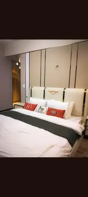 a bedroom with a large bed with red pillows at One winstar realty corp in Manila