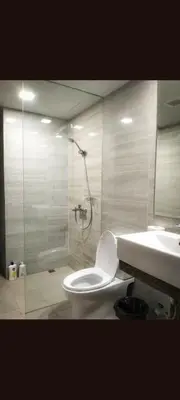 a bathroom with a shower and a toilet and a sink at One winstar realty corp in Manila