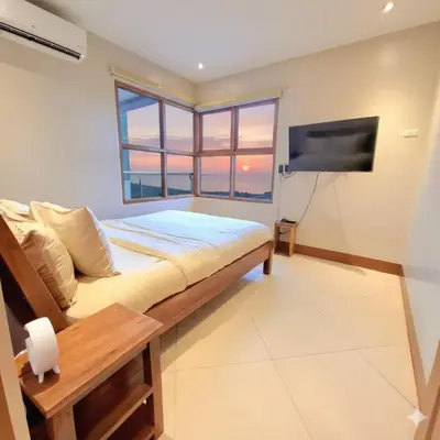 a bedroom with a bed and a flat screen tv at STAYLUXIA BOUTIQUE HOTEL MANILABAYVIEW - 1-5 BR Luxury and Superior Condos with, Balcony, Pool, Netflix & Gym- Housekeeping Available - in Manila