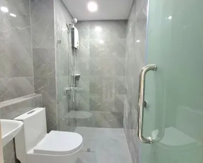 a bathroom with a toilet and a glass shower at STAYLUXIA BOUTIQUE HOTEL MANILABAYVIEW - 1-5 BR Luxury and Superior Condos with, Balcony, Pool, Netflix & Gym- Housekeeping Available - in Manila