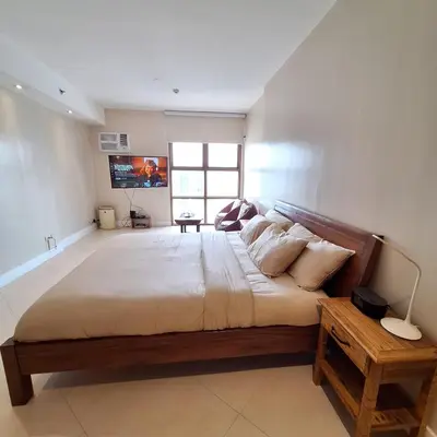 a large bedroom with a large bed in a room at STAYLUXIA BOUTIQUE HOTEL MANILABAYVIEW - 1-5 BR Luxury and Superior Condos with, Balcony, Pool, Netflix & Gym- Housekeeping Available - in Manila