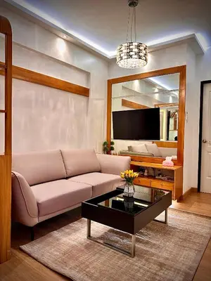 a living room with a couch and a coffee table at The Cozysweet Homestay in Manila