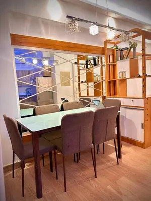 a dining room with a table and chairs at The Cozysweet Homestay in Manila