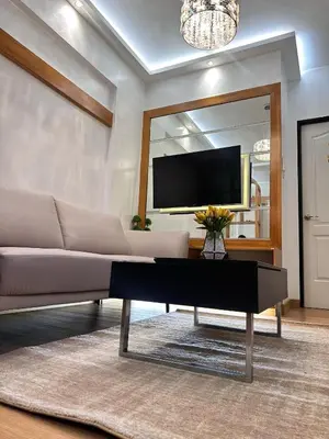 a living room with a couch and a large mirror at The Cozysweet Homestay in Manila