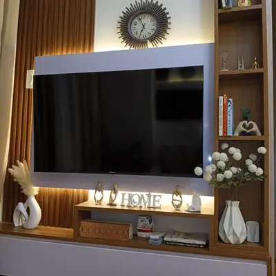 a flat screen tv sitting on top of a shelf at Field Residence Cozy Condo In Paranaque in Manila