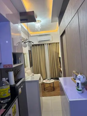 a kitchen with a counter top and a room at Field Residence Cozy Condo In Paranaque in Manila