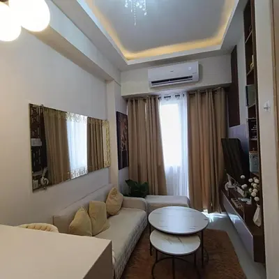 a living room with a couch and a table at Field Residence Cozy Condo In Paranaque in Manila