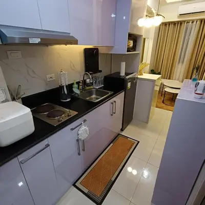 a kitchen with a sink and a counter top at Field Residence Cozy Condo In Paranaque in Manila