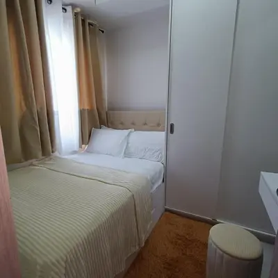 a small bedroom with a bed and a window at Field Residence Cozy Condo In Paranaque in Manila