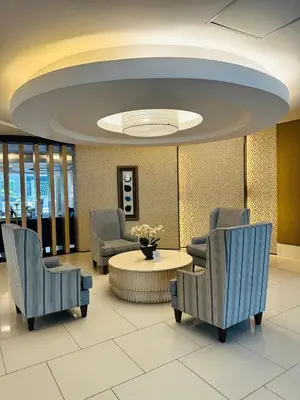 a lobby with chairs and a table in a building at 1232A Near MOA and Airport Pool View Balcony in Manila