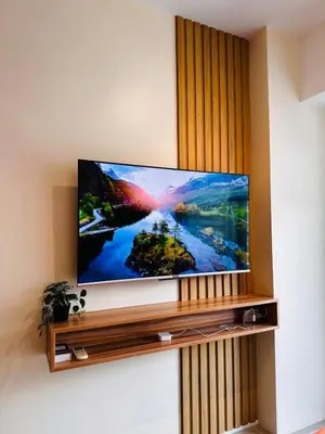 a flat screen tv sitting on a wall at 1232A Near MOA and Airport Pool View Balcony in Manila