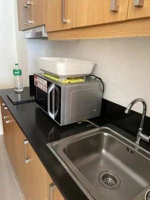 a toaster oven sitting on top of a kitchen counter at 1232A Near MOA and Airport Pool View Balcony in Manila