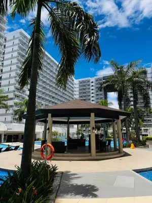 a gazebo in front of a large building at 1232A Near MOA and Airport Pool View Balcony in Manila