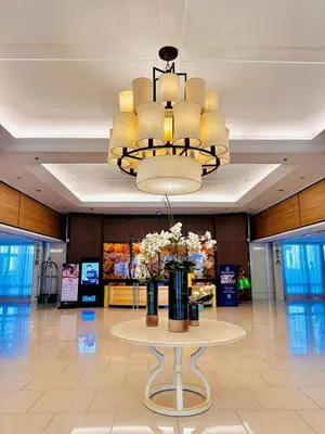 a chandelier and a table with flowers on it at 1232A Near MOA and Airport Pool View Balcony in Manila