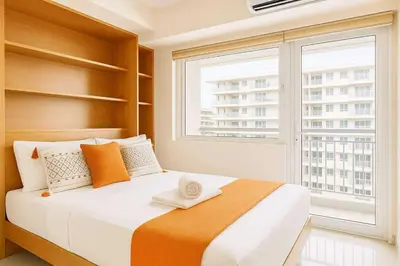 a bedroom with a large bed with a large window at 729A Near MOA and Airport PoolView Balcony in Manila