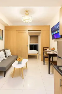 a living room with a couch and a table at 729A Near MOA and Airport PoolView Balcony in Manila