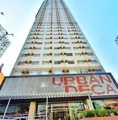 a tall building with a sign in front of it at Gaby's Condotel in Manila