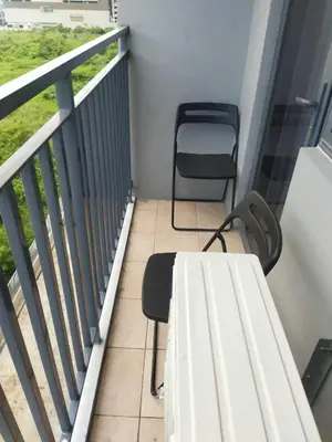 a balcony with a table and a chair at JAS Staycation in Manila