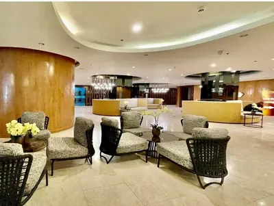 a lobby with chairs and a table in a building at JAS Staycation in Manila