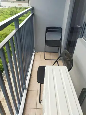a balcony with a bench and a chair on it at JAS Staycation in Manila