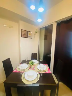 a dining room table with plates on top of it at Sole Sisters Staycation in Manila