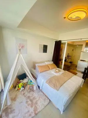 a bedroom with two beds and a tent at Sole Sisters Staycation in Manila