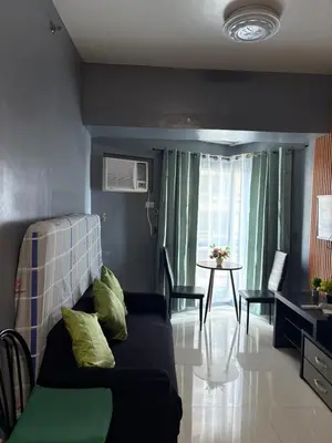a living room with a couch and a table at Family Budget Room in Manila