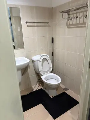 a bathroom with a toilet and a sink at Family Budget Room in Manila