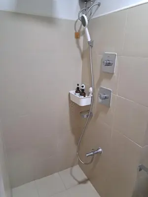 a bathroom with a shower with a shower head at Yutori Haus at Shore 3 Tower 2 near Mall of Asia Pasay City in Manila